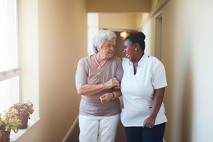 Portrait,Of,Happy,Female,Caregiver,And,Senior,Woman,Walking,Together